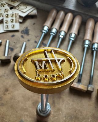 Custom branding iron with initials.